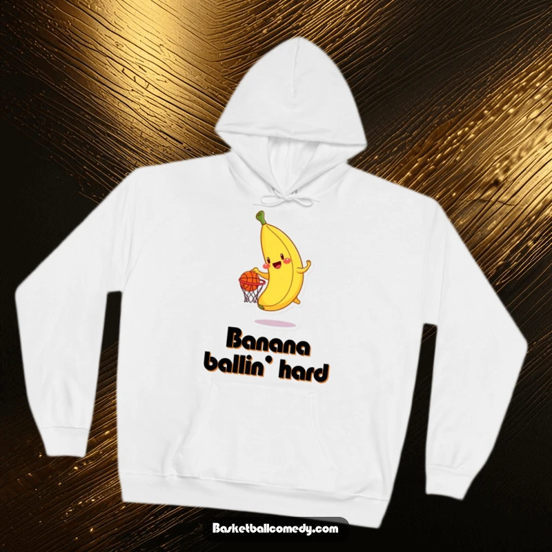 Funny banana hoodie, a smiling banana character trying to score a basketball dunk, combining comfort and humor.